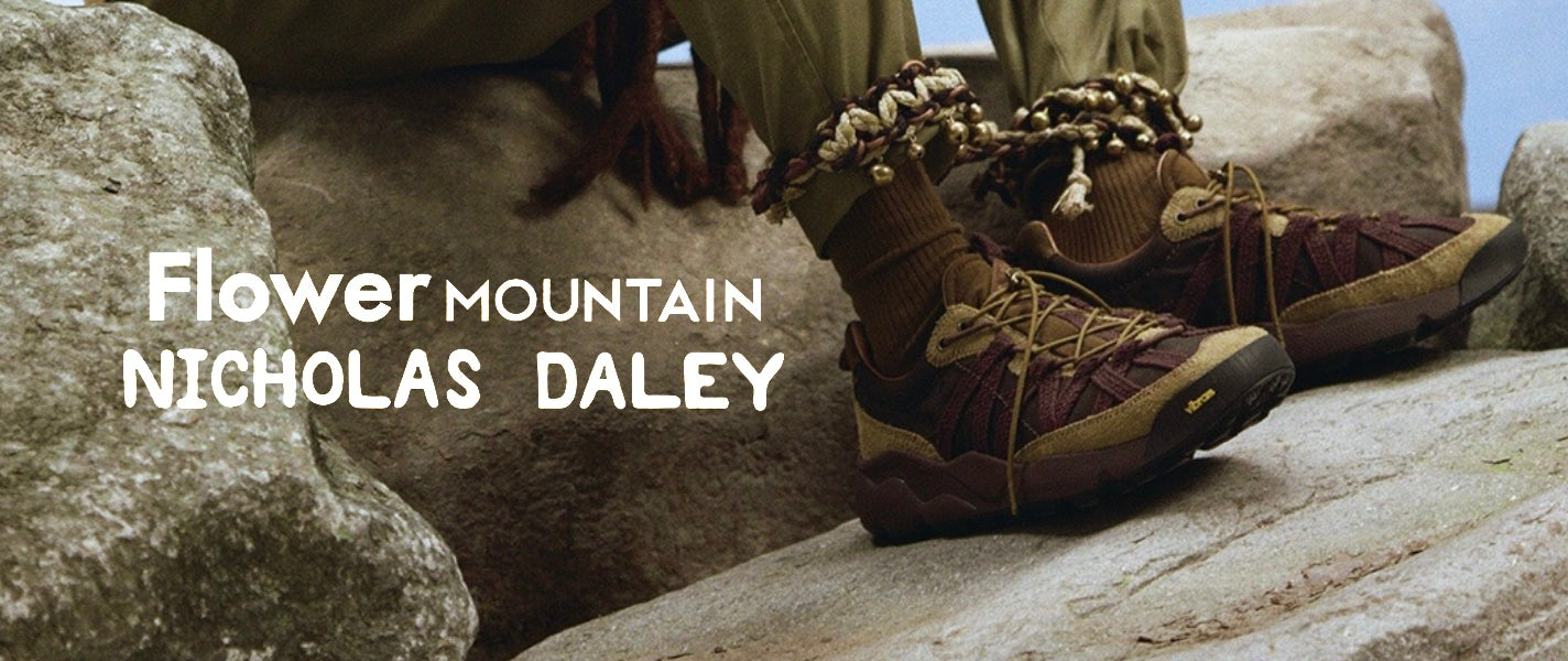 Brown hiking boots on rocks with 'Flower Mountain x Nicholas Daley' AW25 Colab